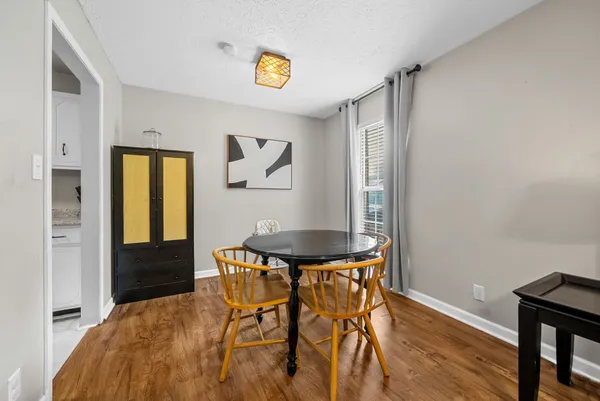 a view of a dining room with furniture and window