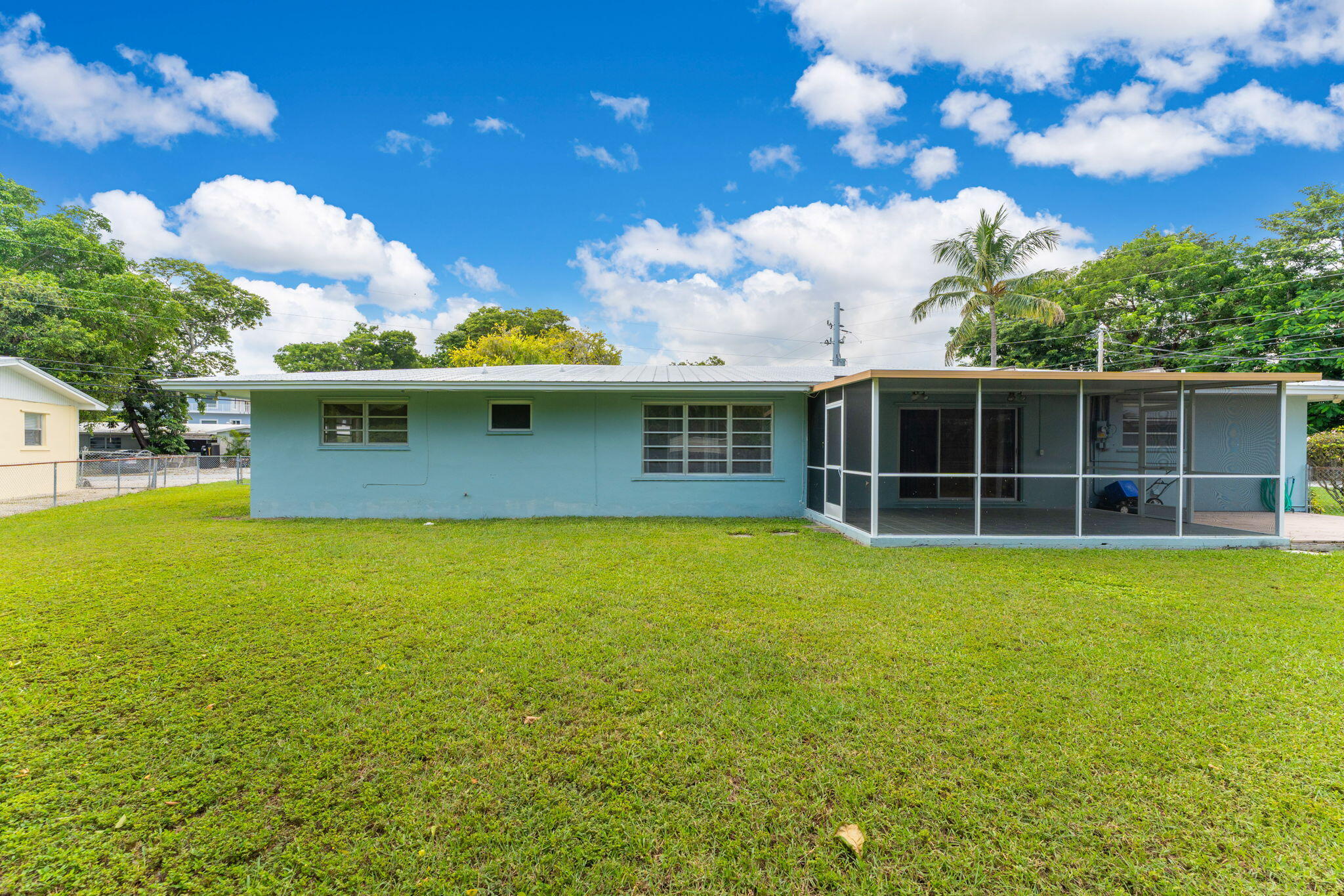 920 La Paloma Road Key Largo, FL 33037 - Photo 13 of 44 a view of a house with a backyard and a tree