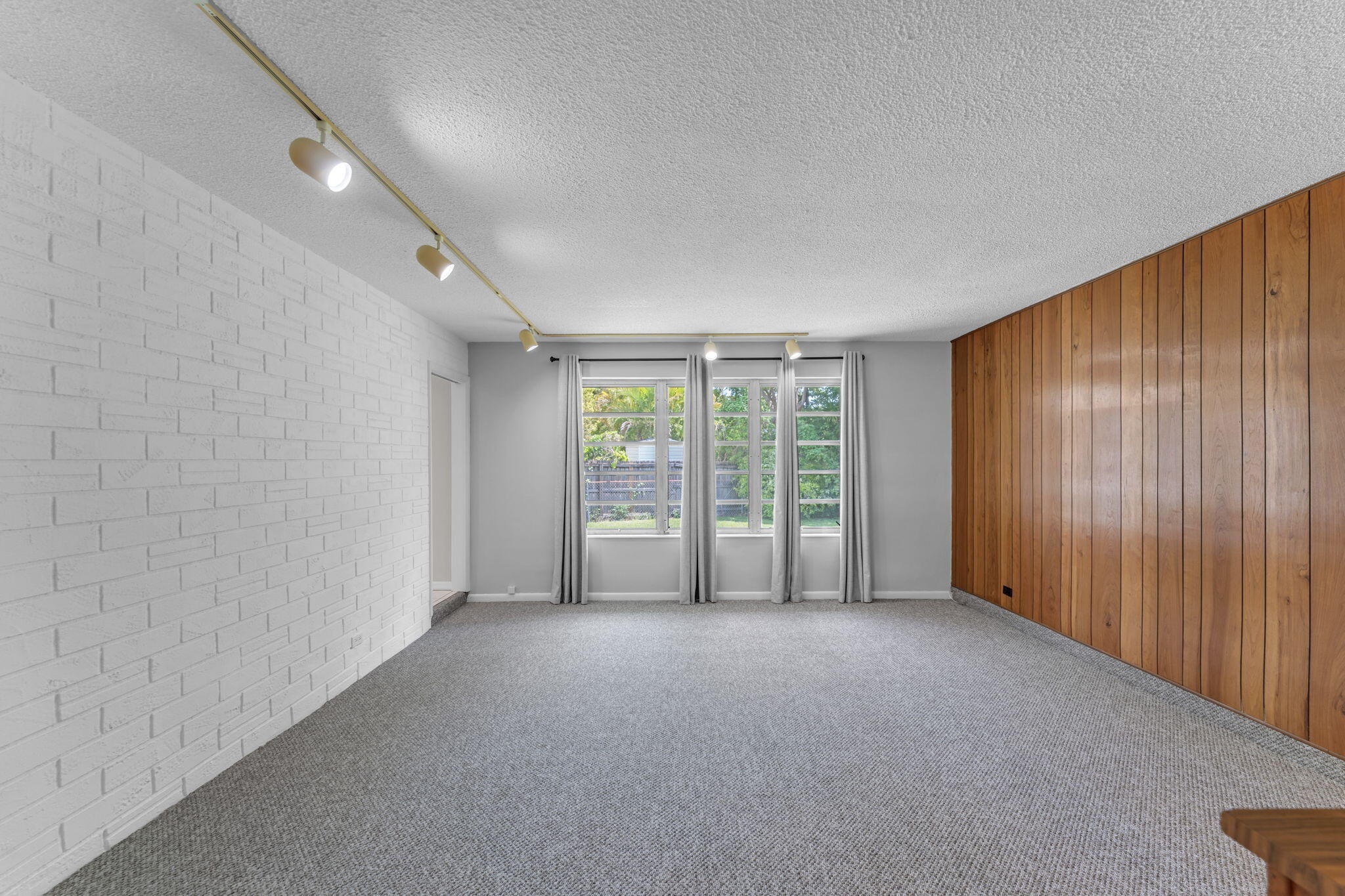 920 La Paloma Road Key Largo, FL 33037 - Photo 16 of 44 a view of an empty room with wooden floor and a window