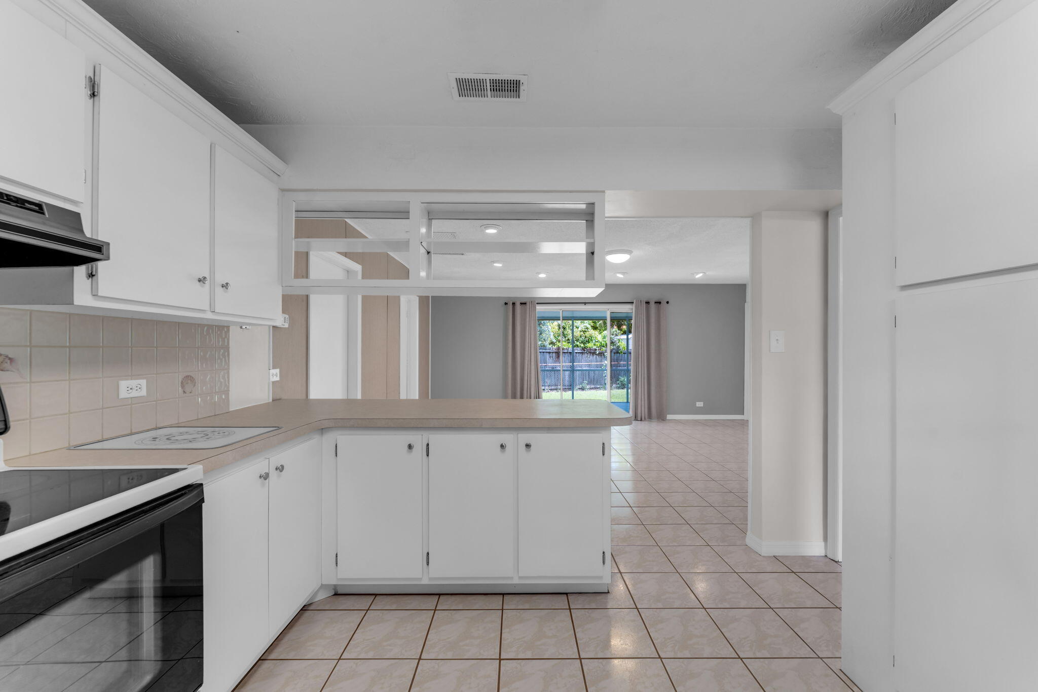 920 La Paloma Road Key Largo, FL 33037 - Photo 19 of 44 a kitchen with white cabinets and window