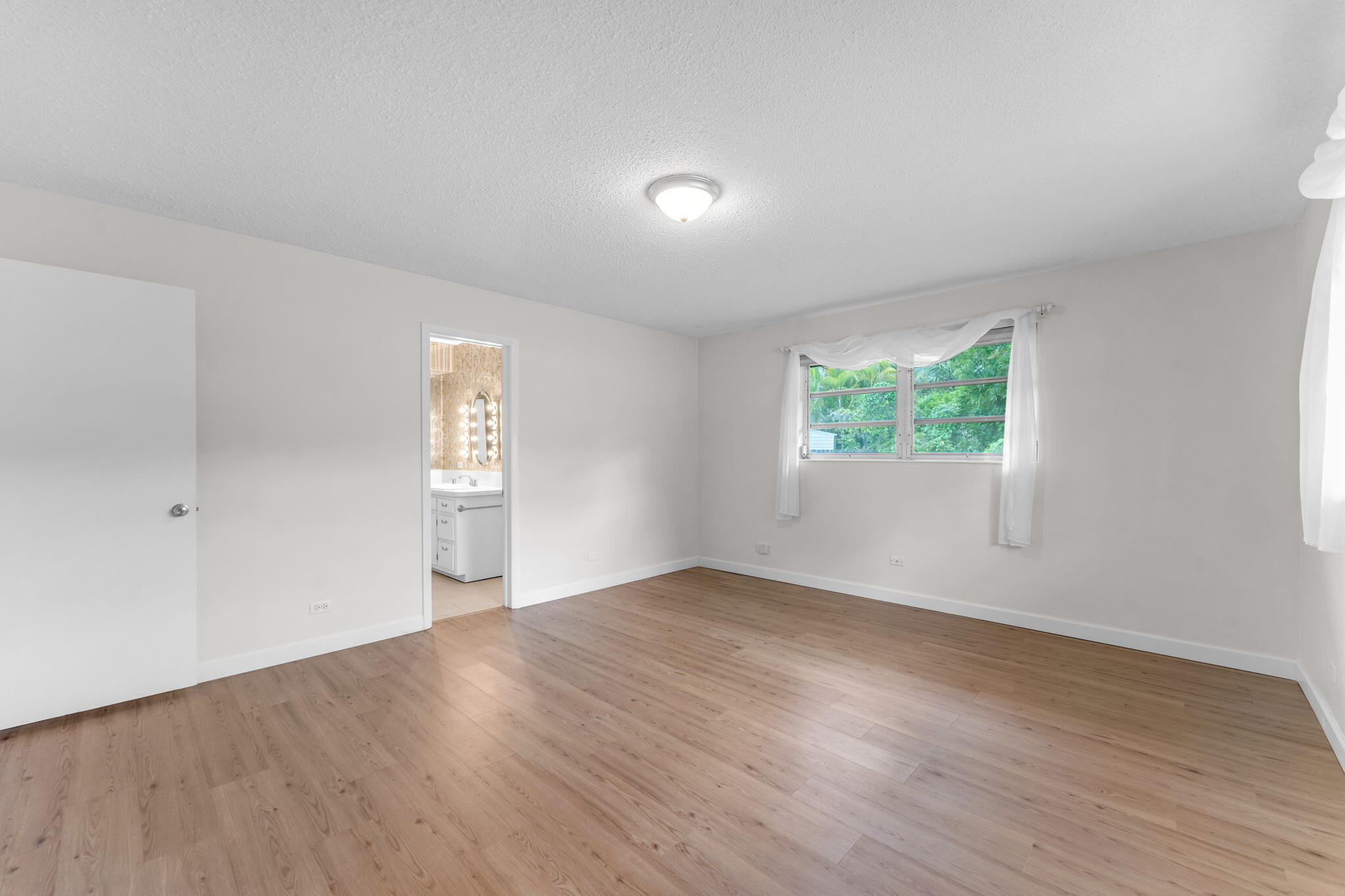 920 La Paloma Road Key Largo, FL 33037 - Photo 22 of 44 an empty room with wooden floor and windows