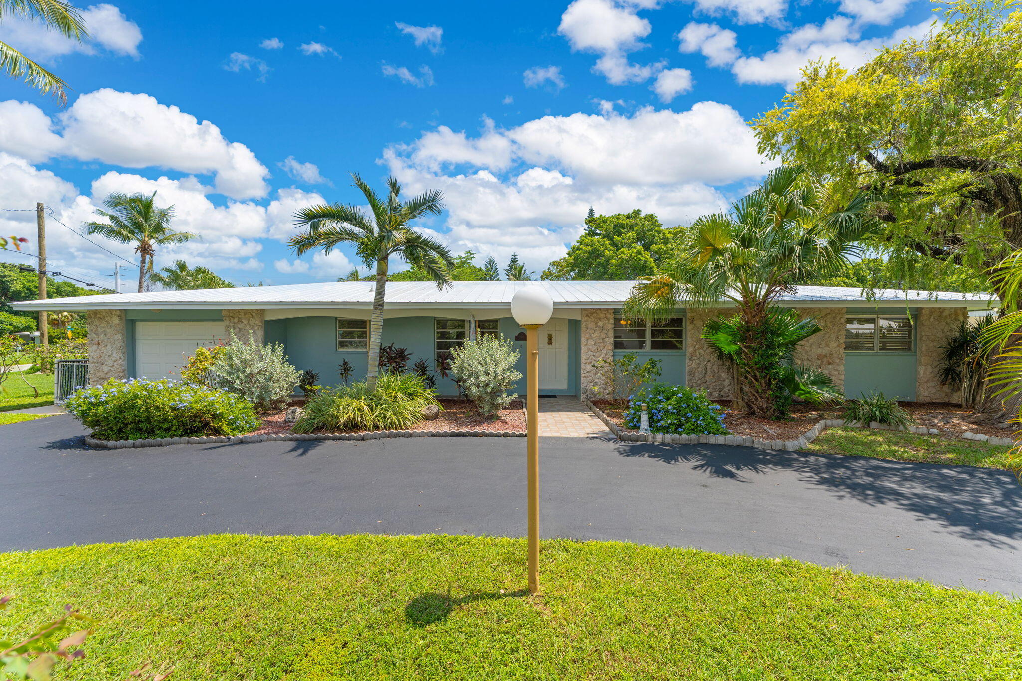 920 La Paloma Road Key Largo, FL 33037 - Photo 2 of 44 a front view of a house with a garden
