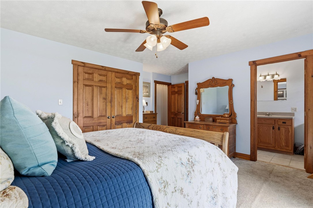 4971 Lackey Road Cedarville, OH 45314 - Photo 37 of 79 This inviting bedroom features rich wooden accents and direct access to a private bath.