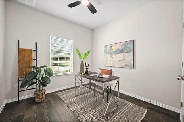 a living room with furniture and a potted plant
