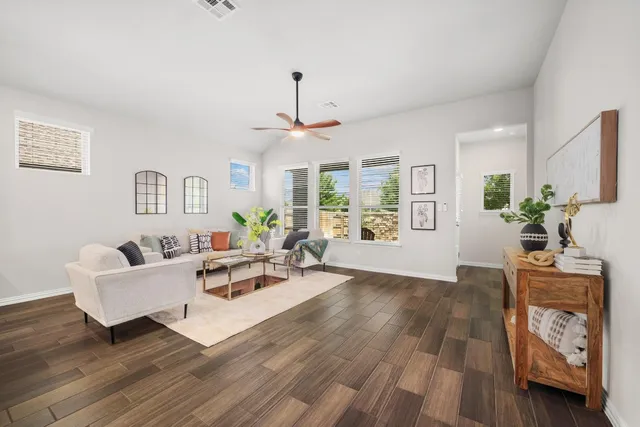 a living room with furniture and wooden floor
