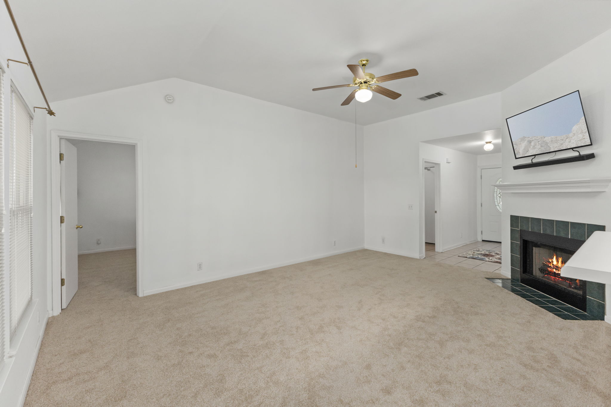 290 Bailey Loop Kyle, TX 78640 - Photo 9 of 33 Living area featuring a vaulted ceiling and light beige carpeting