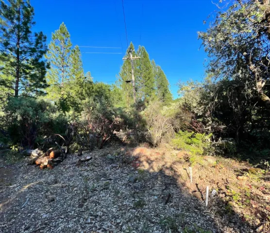 a backyard of a house with a yard and outdoor seating