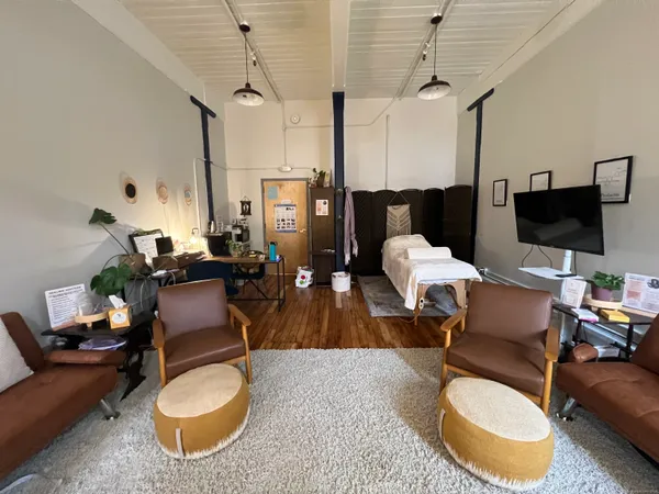 a living room with furniture a rug and a chandelier