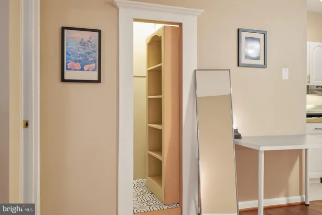 a view of a hallway with paintings on the wall