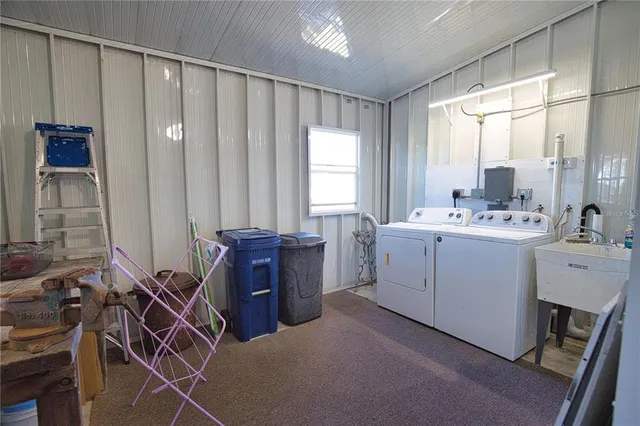 a utility room with cabinets dryer and washer