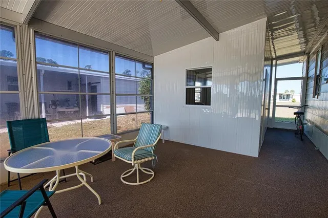 a view of a dining room with furniture and window