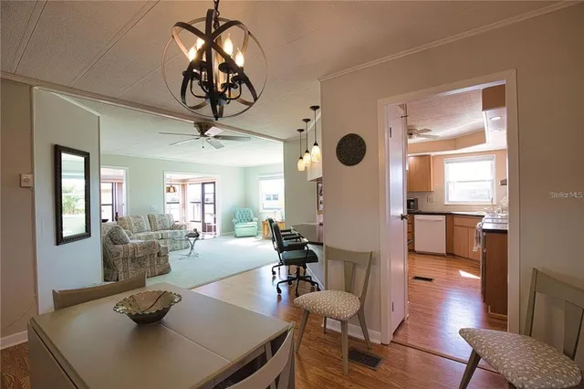 a view of a dining room with furniture wooden floor and chandelier