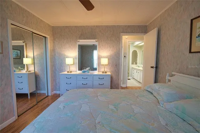 a bedroom with a large bed and a chandelier