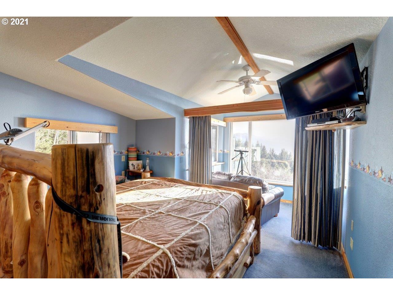 32307 Ruby Lane Cannon Beach, OR 97110 - Photo 14 of 27 a bedroom with a bed tv and a window