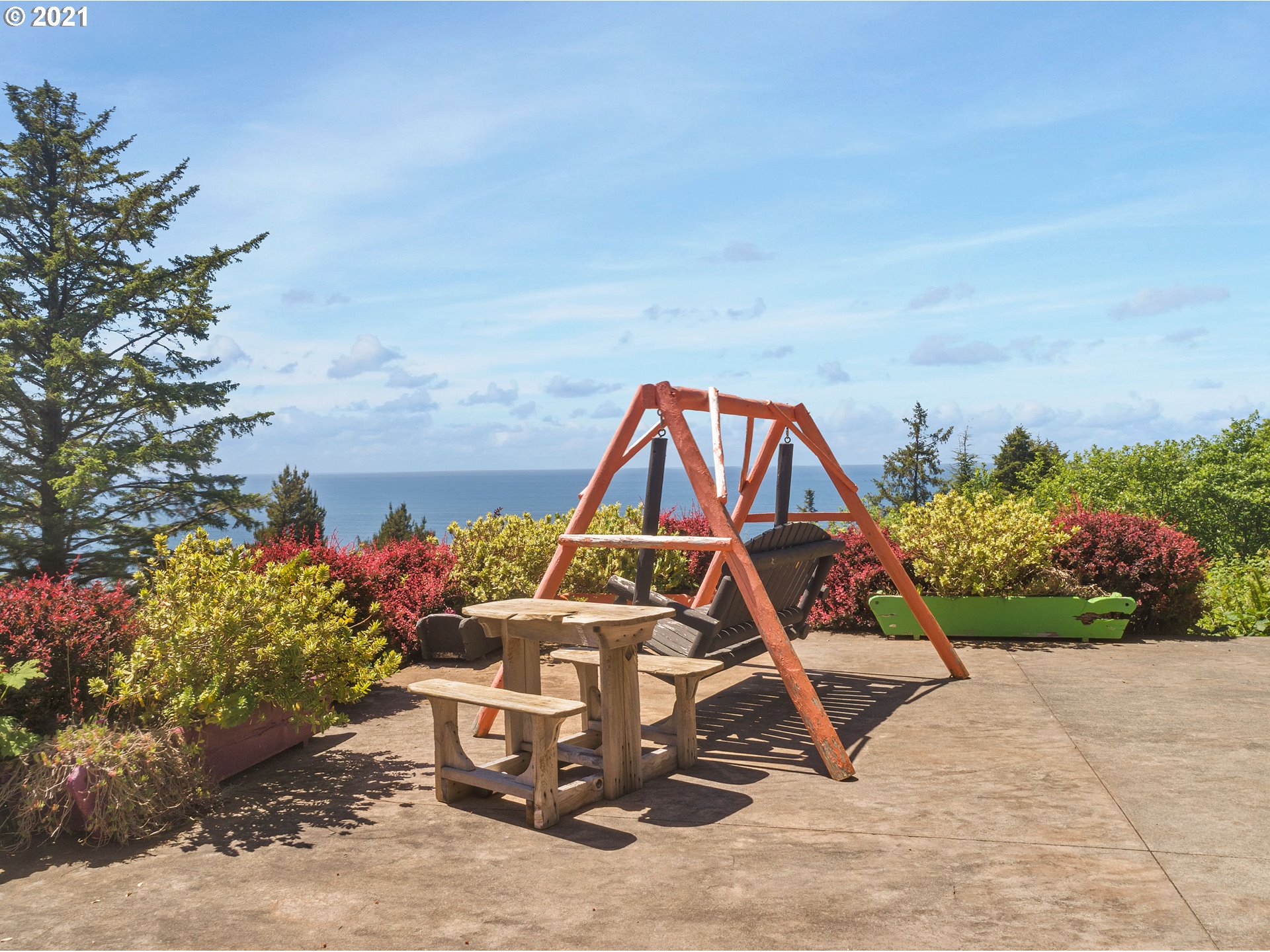 32307 Ruby Lane Cannon Beach, OR 97110 - Photo 25 of 27 a view of a bench in front of a house