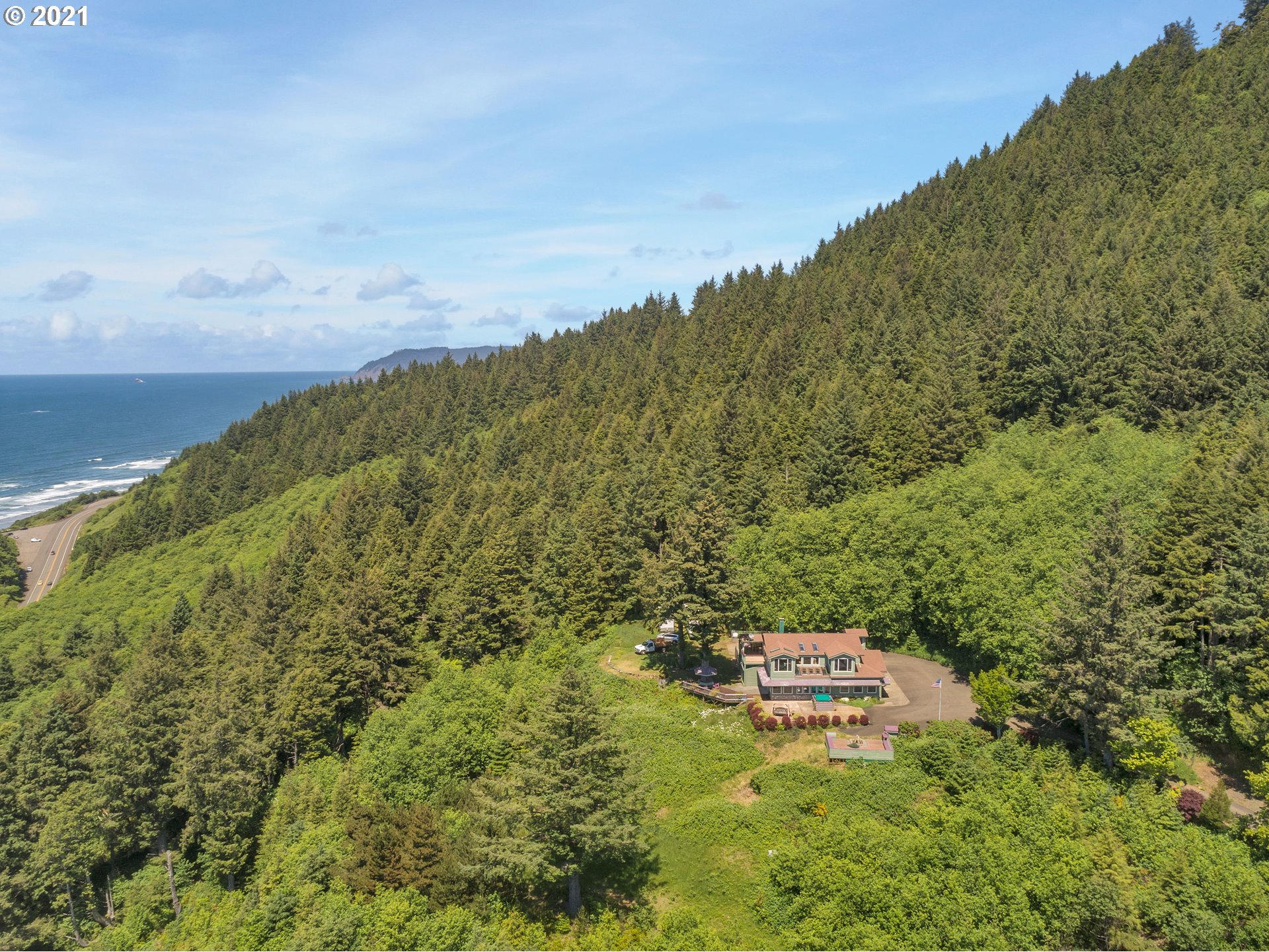 32307 Ruby Lane Cannon Beach, OR 97110 - Photo 27 of 27 a backyard of a house with lots of green space and fog