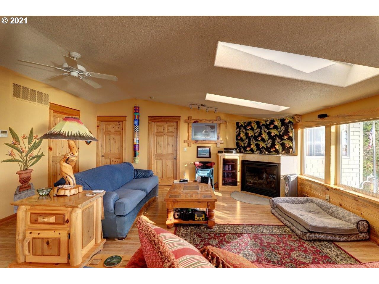 32307 Ruby Lane Cannon Beach, OR 97110 - Photo 10 of 27 a living room with furniture a fireplace and a flat screen tv