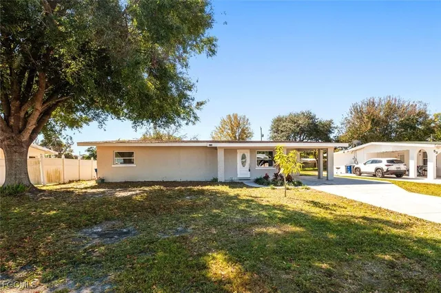 a view of a house with yard and sitting area