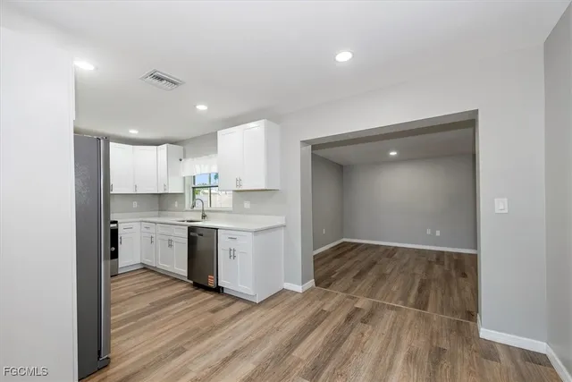 a kitchen with stainless steel appliances granite countertop a sink and a stove