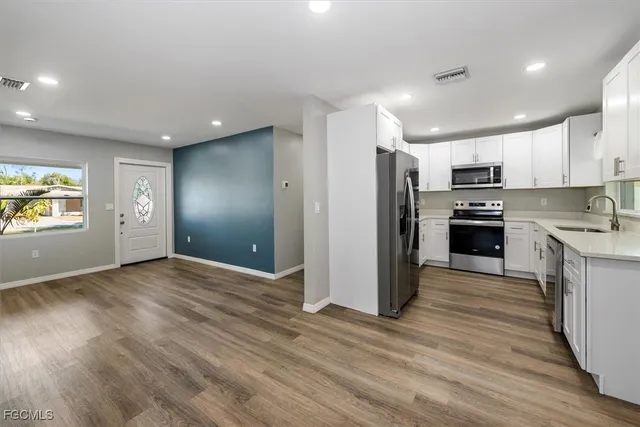 a kitchen with a sink stove and cabinets