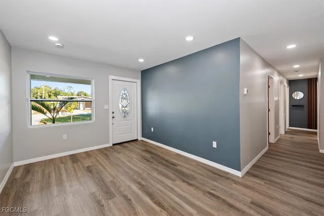 a view of empty room with wooden floor