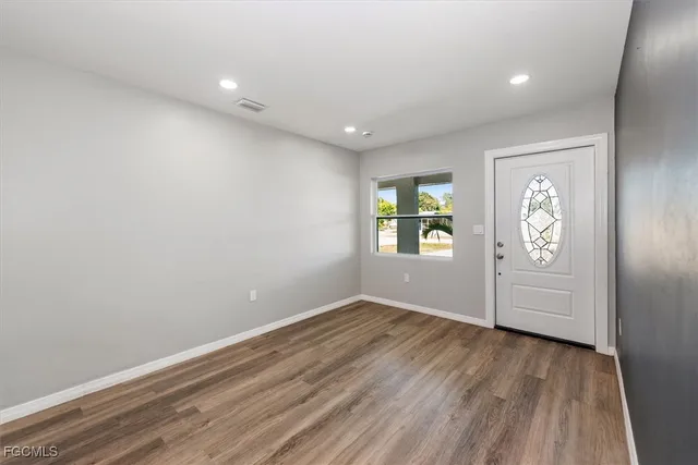 a view of a kitchen with a refrigerator and a stove top oven