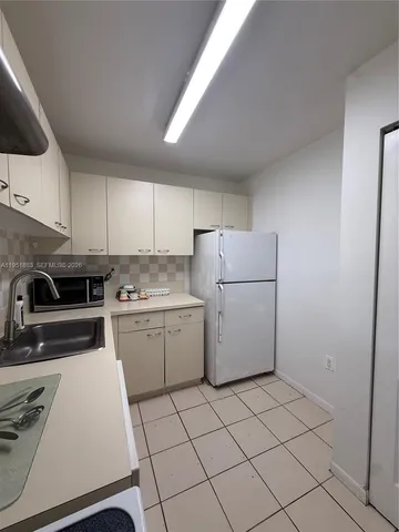 a kitchen with a cabinets and white appliances
