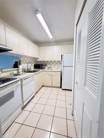 a kitchen with cabinets and white appliances