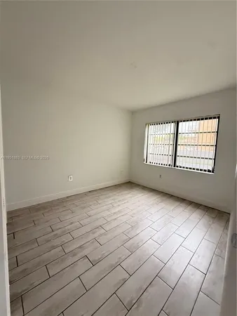 a view of an empty room with windows