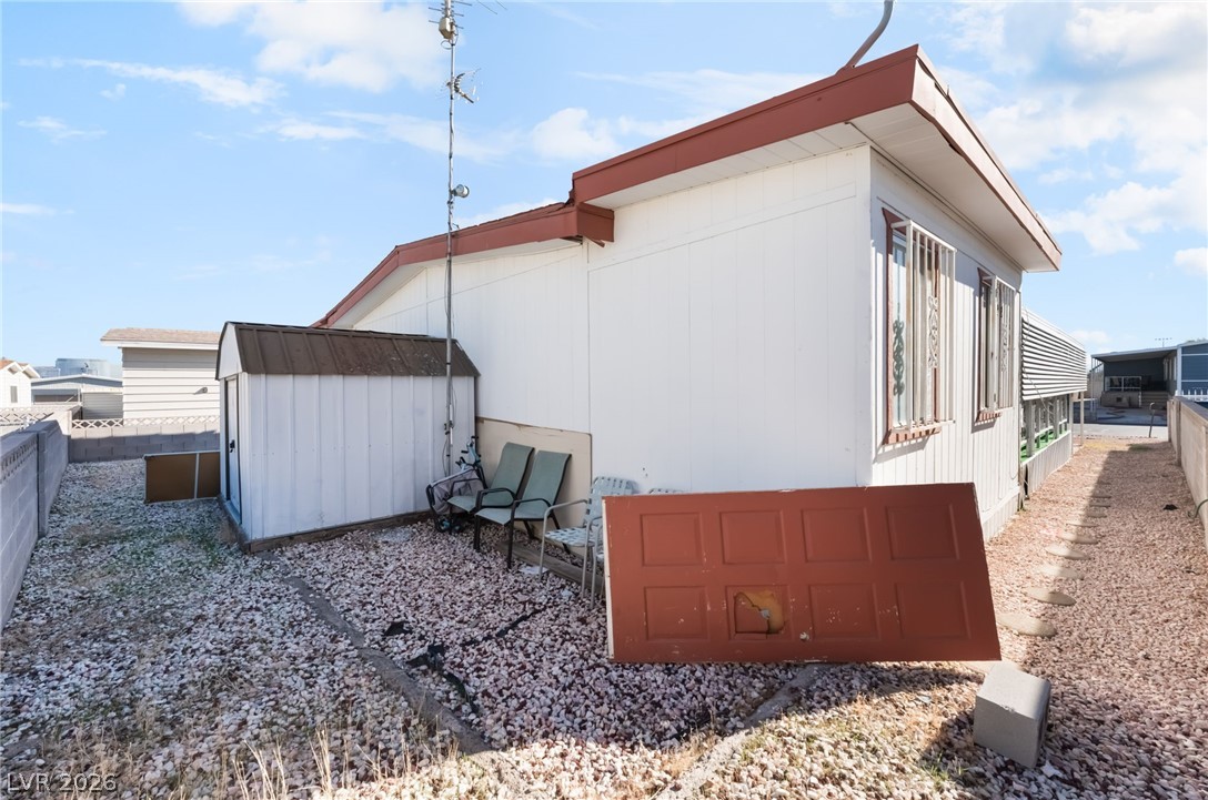 4980 Ridge Drive Las Vegas, NV 89103 - Photo 33 of 36 View of side of home featuring a storage shed and a fenced backyard