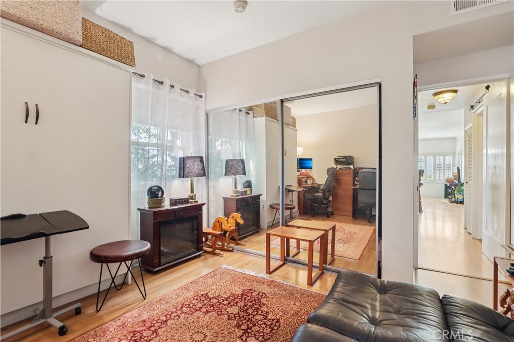 360 South Los Robles Avenue, Unit 11 Pasadena, CA 91101 - Photo 9 of 12 a living room with furniture and a large window