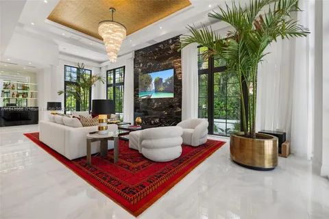 a living room with furniture and a book shelf