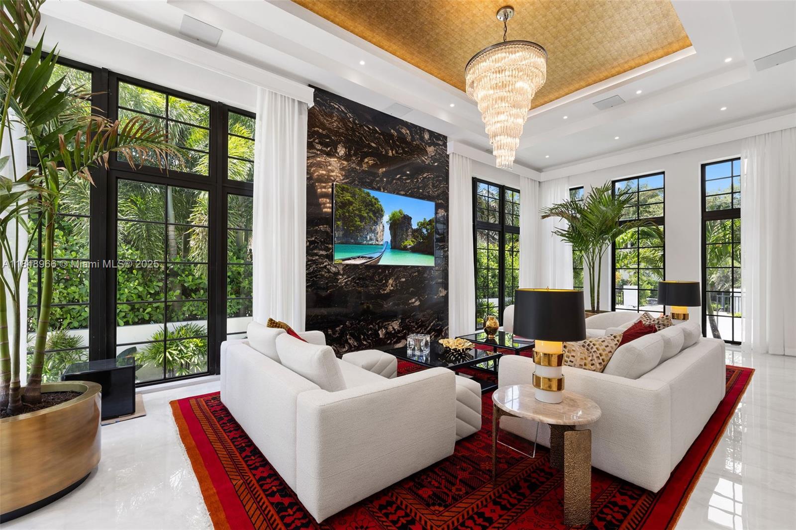 2321 North Bay Road Miami Beach, FL 33140 - Photo 15 of 77 a living room with patio floor to ceiling windows and a chandelier