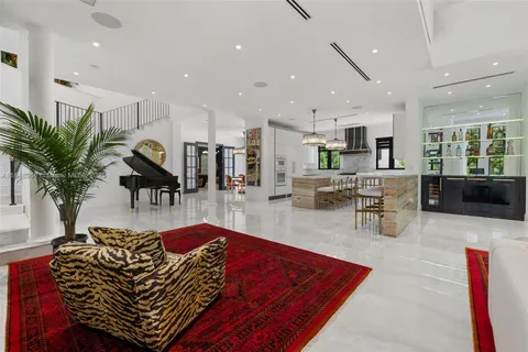 a room with pool table and windows