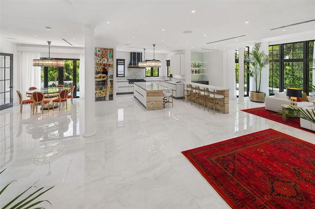 a bedroom with furniture and a large window