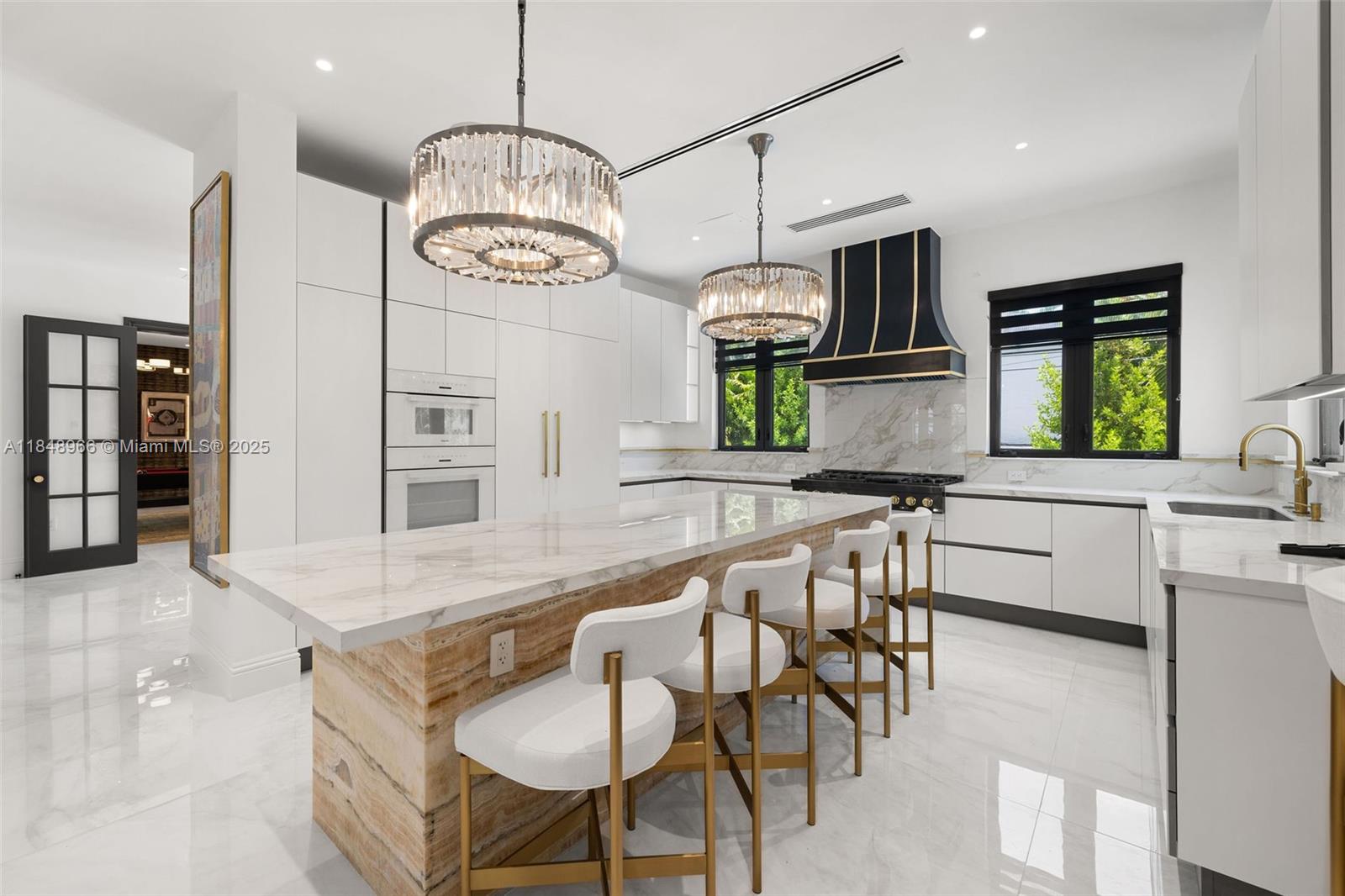 2321 North Bay Road Miami Beach, FL 33140 - Photo 26 of 77 a large kitchen with a table and chairs