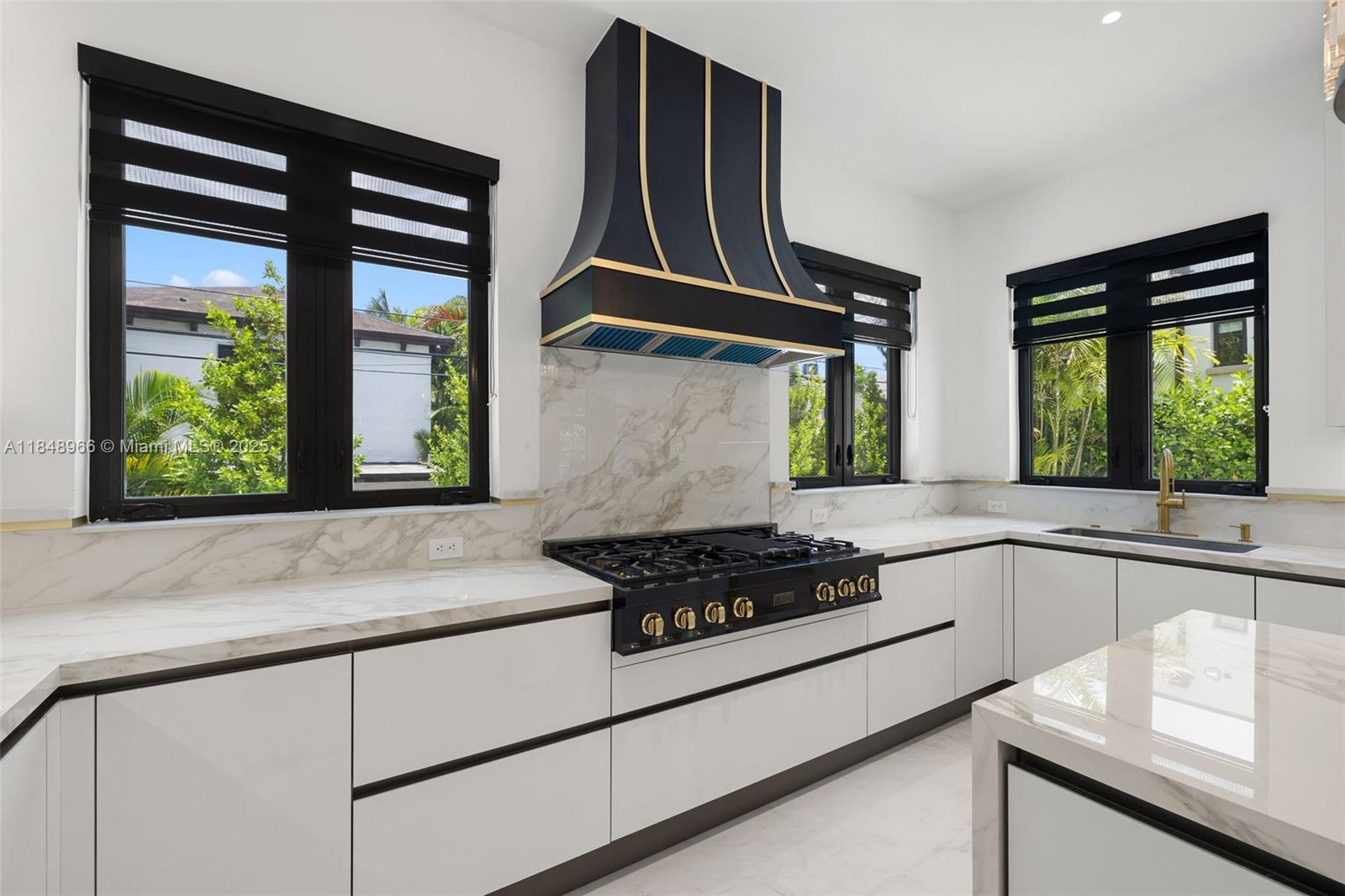 2321 North Bay Road Miami Beach, FL 33140 - Photo 27 of 77 a kitchen with stainless steel appliances granite countertop a stove a sink and a granite counter tops