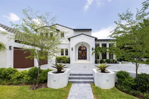 a view of a house with a patio and a yard