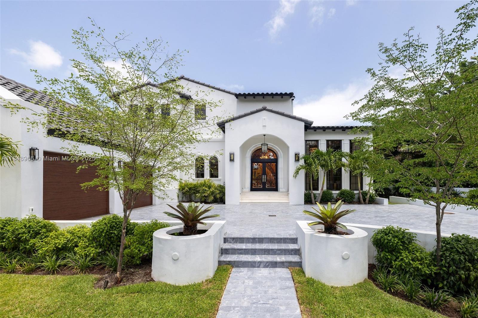 2321 North Bay Road Miami Beach, FL 33140 - Photo 3 of 77 a front view of a house with garden