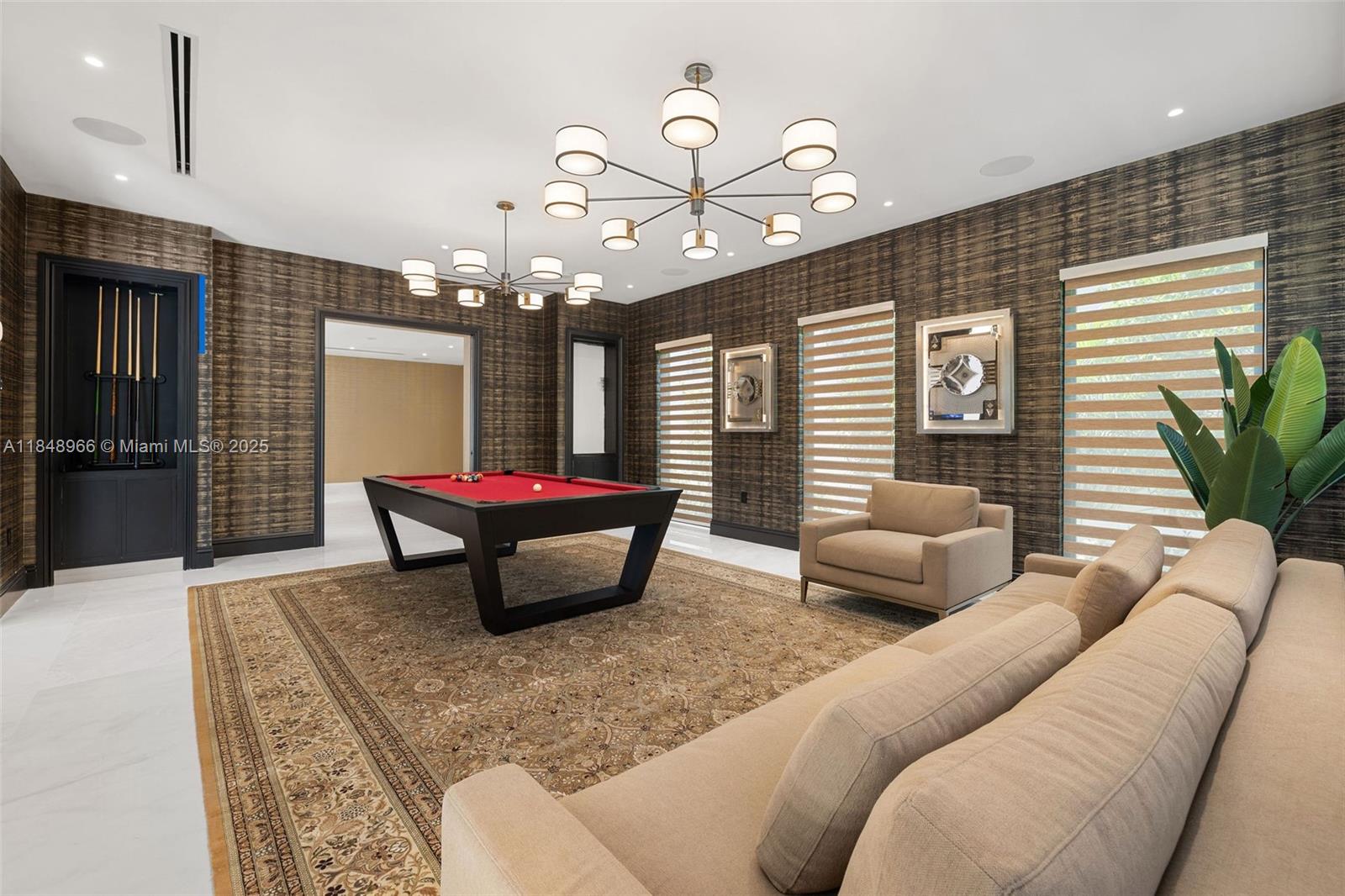 2321 North Bay Road Miami Beach, FL 33140 - Photo 33 of 77 a living room with furniture and a chandelier
