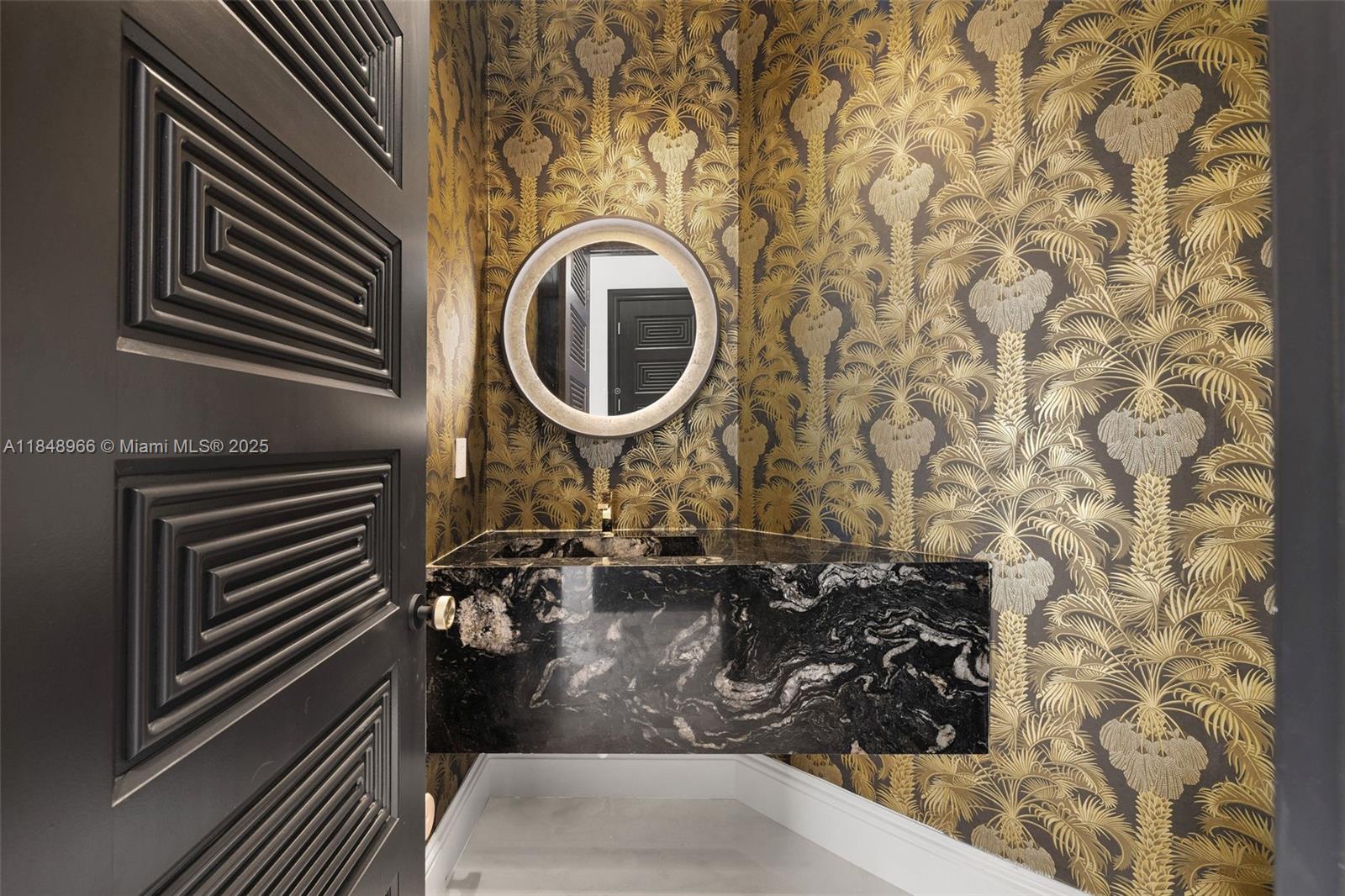 2321 North Bay Road Miami Beach, FL 33140 - Photo 38 of 77 a bathroom with a sink and a mirror