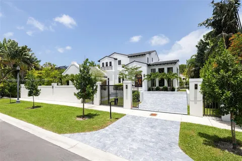 a living room with patio furniture and a potted plant