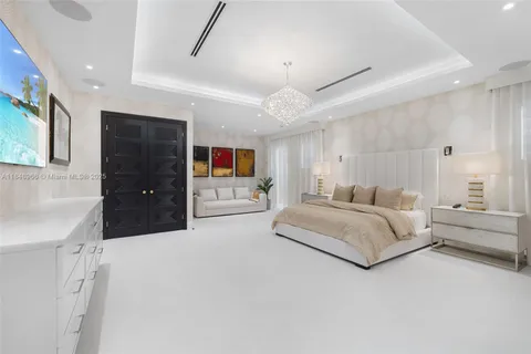 an aerial view of residential houses with outdoor space and trees