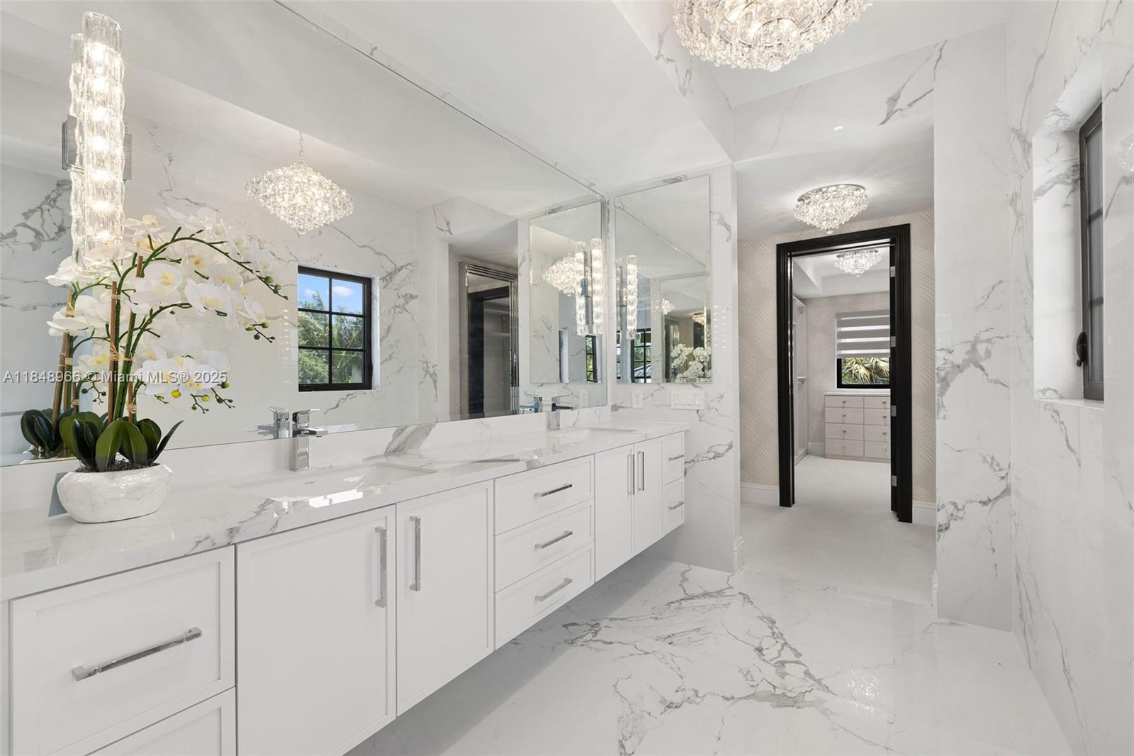 2321 North Bay Road Miami Beach, FL 33140 - Photo 49 of 77 a spacious en suite bathroom with a granite countertop sink mirror and next to a window