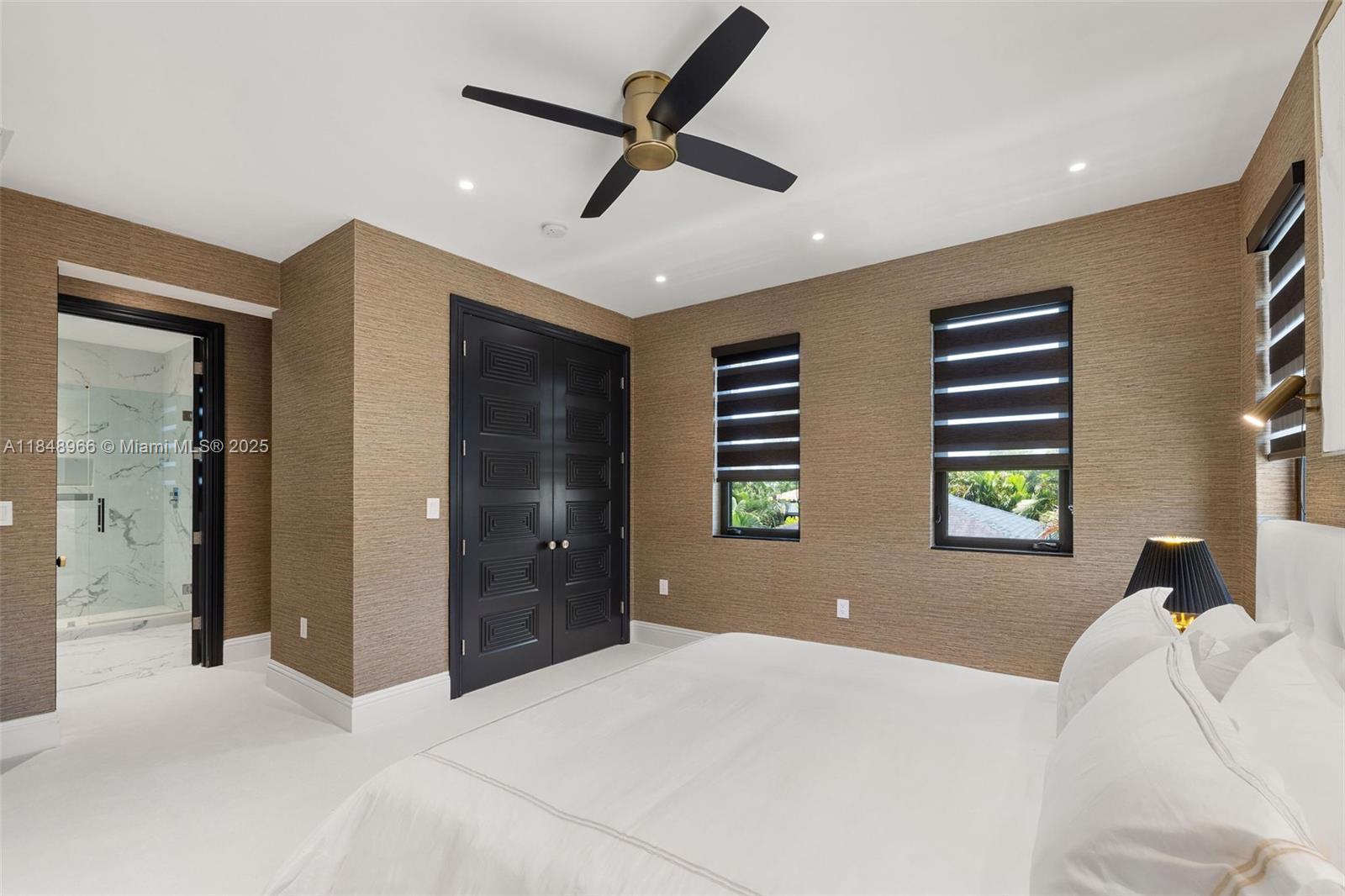 2321 North Bay Road Miami Beach, FL 33140 - Photo 52 of 77 a bedroom with a bed and a window