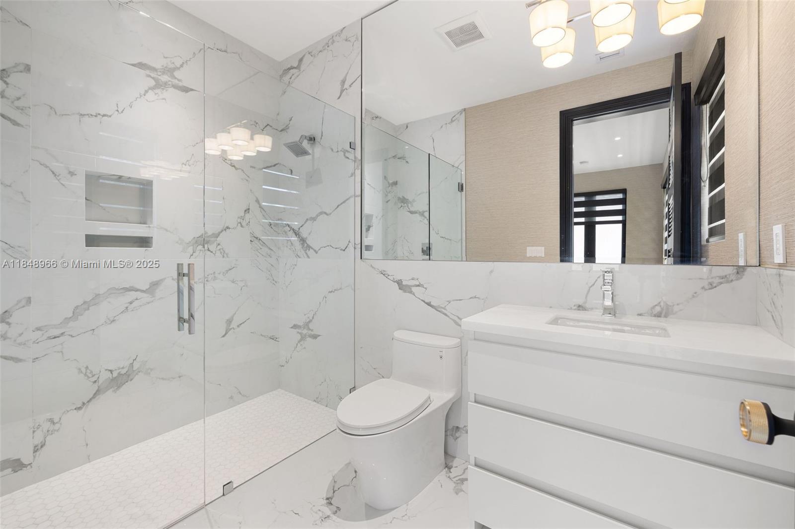 2321 North Bay Road Miami Beach, FL 33140 - Photo 57 of 77 a bathroom with a sink a toilet and shower