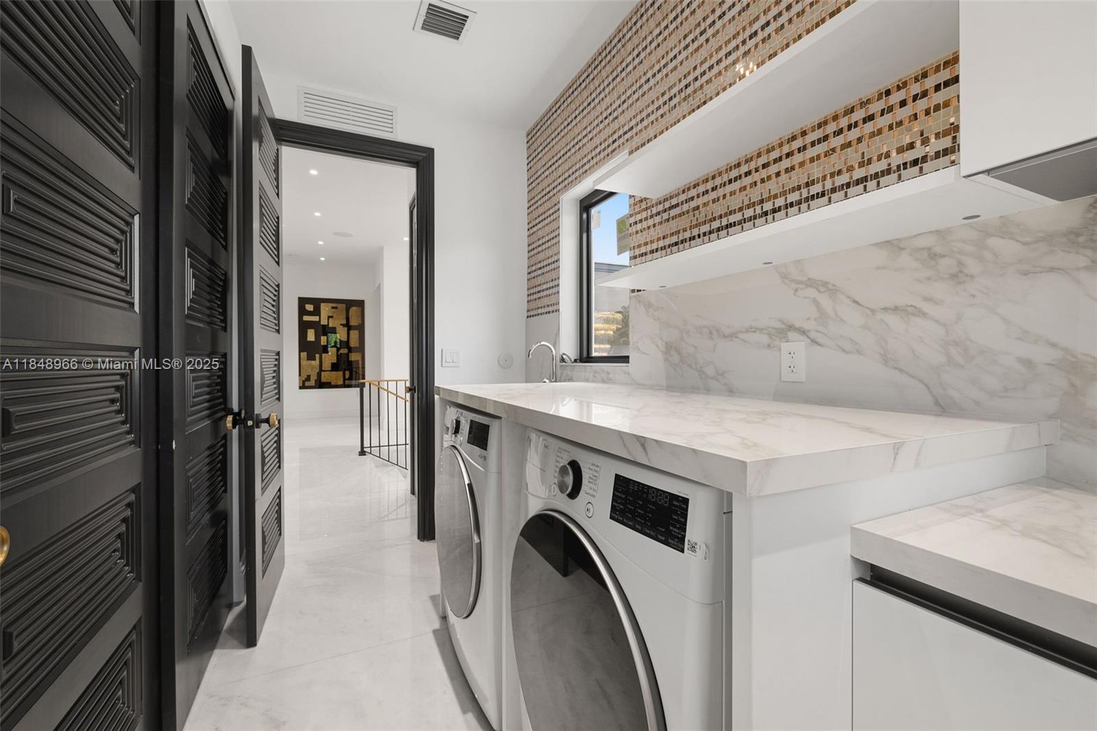 2321 North Bay Road Miami Beach, FL 33140 - Photo 60 of 77 a utility room with dryer and washer