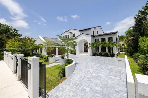 a living room with fireplace furniture and a large window