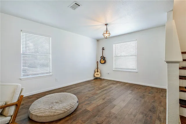 an empty room with windows and closet