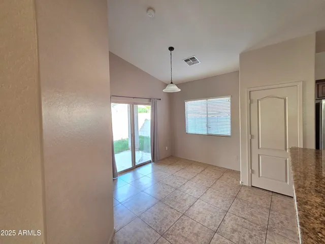 a kitchen with stainless steel appliances granite countertop a refrigerator sink and stove